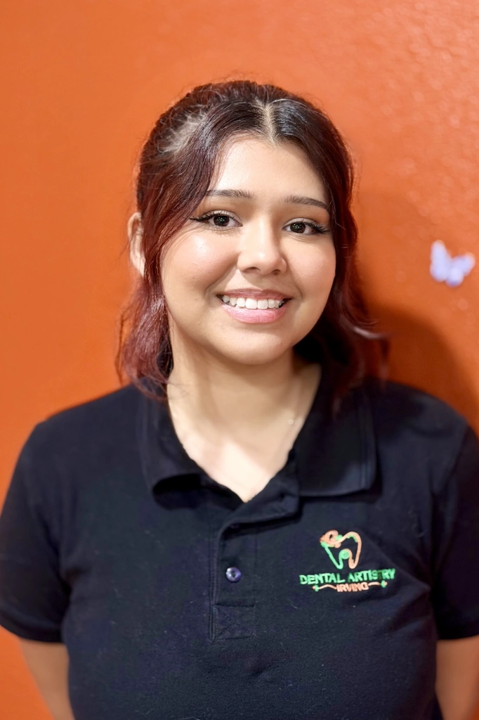 Beatriz Macias, Registered Dental Assistant and Office Manager at Dental Artistry Irving, smiling in her black scrub uniform