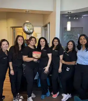 dr. vijaya kallam with her dental team in frisco