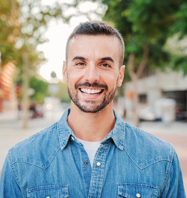 Man smiling outdoors after preventative dental care treatment at The Dentist Place of Clearwater in Clearwater, FL