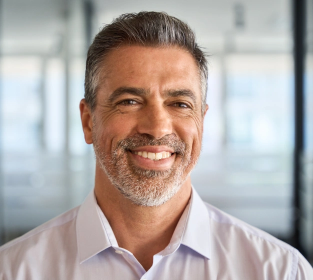 Middle-aged man smiling confidently after full mouth restoration treatment at The Dentist Place of Clearwater in Clearwater, FL