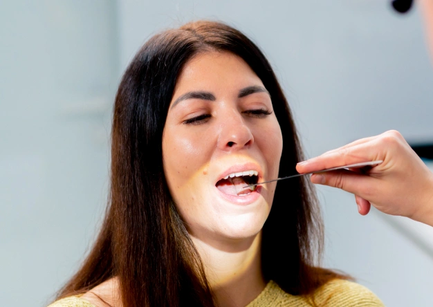 Dentist performing a minor oral surgery procedure on a patient at The Dentist Place of Clearwater in Clearwater, FL