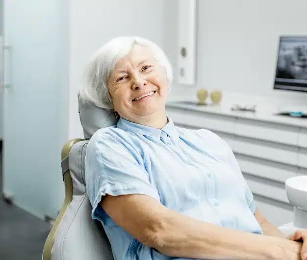 Older female patient smiling comfortably in the dental chair after root canal therapy at The Dentist Place of Clearwater in Clearwater, FL