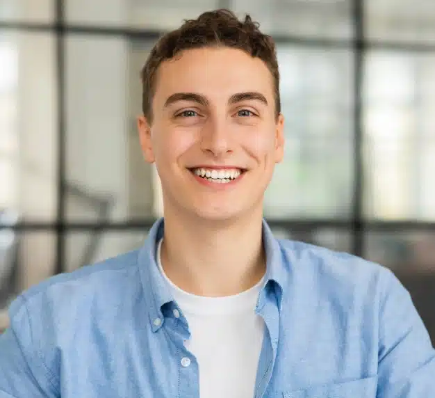 Young man smiling with bright white teeth after professional teeth whitening at The Dentist Place of Clearwater in Clearwater, FL