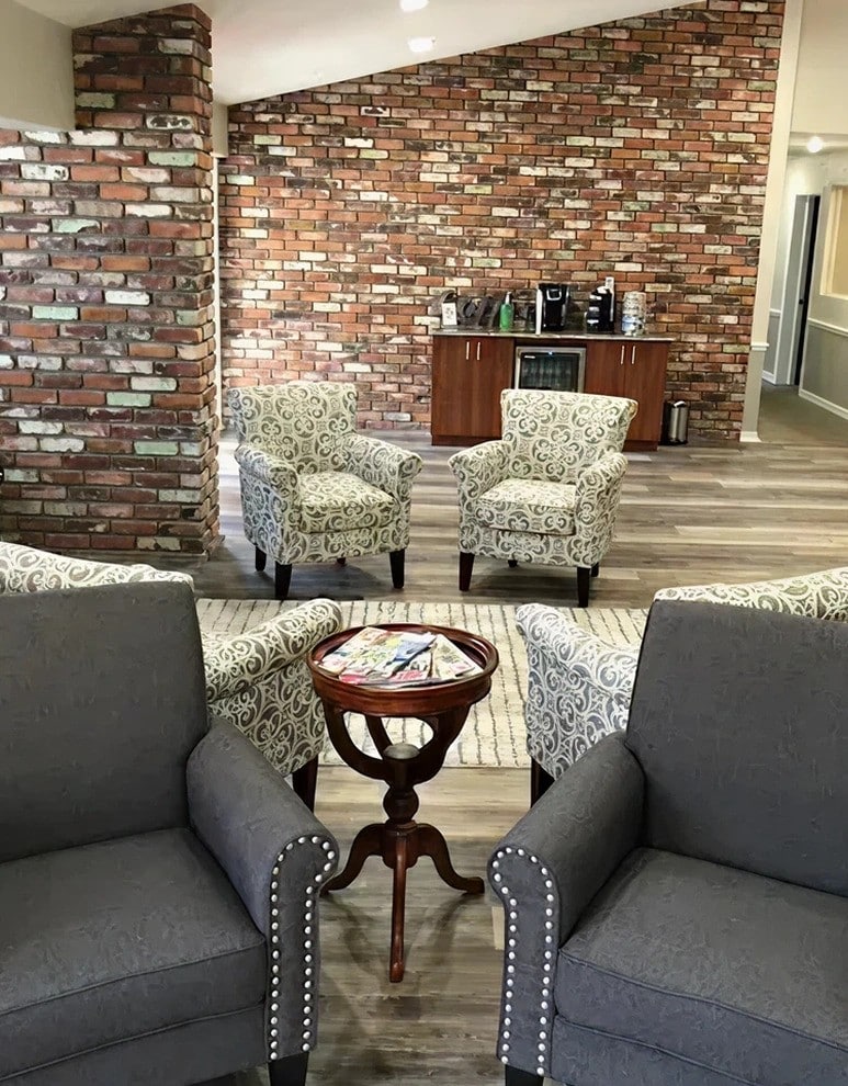 Comfortable waiting room with brick walls and cozy seating area