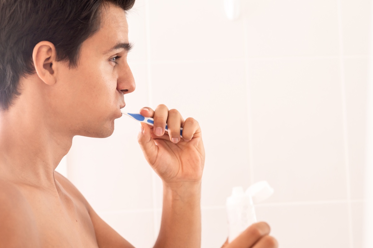 Person brushing teeth correctly using a soft toothbrush