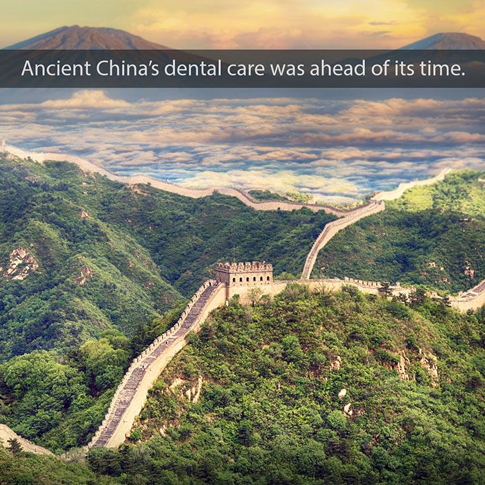 Great Wall of China winding through mountainous landscape at sunset with text about ancient dental care.