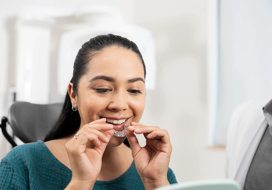 Woman holding ClearCorrect aligners at Druid Hills Dental in Decatur, GA