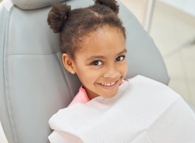 Smiling child receiving early childhood dental care