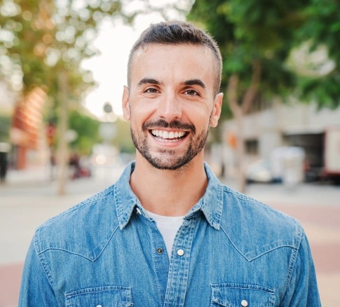 Patient smiling after restorative dentistry treatment in Carthage