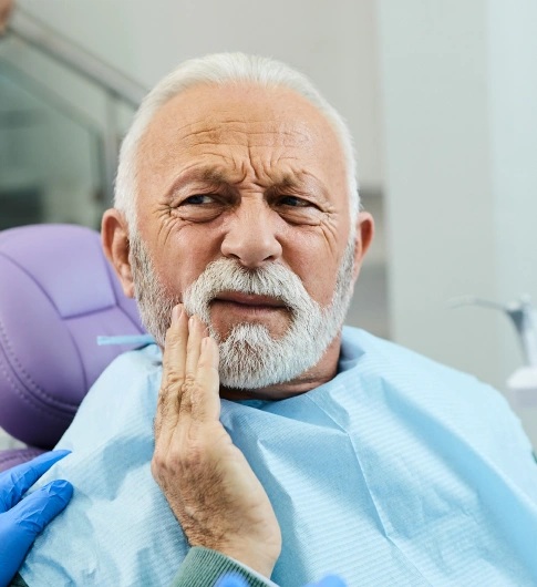 Patient with tooth pain receiving tooth extraction care in Carthage for relief from dental discomfort