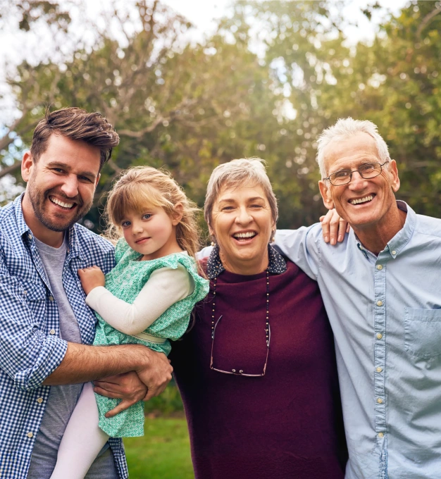 Happy multi-generational family smiling outdoors together in Clewiston, FL.