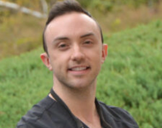 Dr. Alexander Gorlin, dentist at Clewiston dental practice, smiling outdoors.