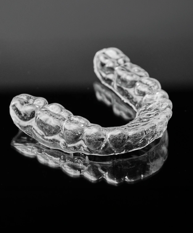 Clear nightguard aligner showing upper and lower teeth impressions for dental bite protection.