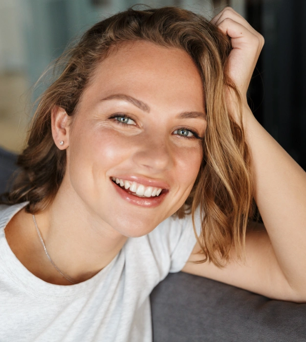 Young woman with a bright, healthy smile displaying results from a dental smile makeover.