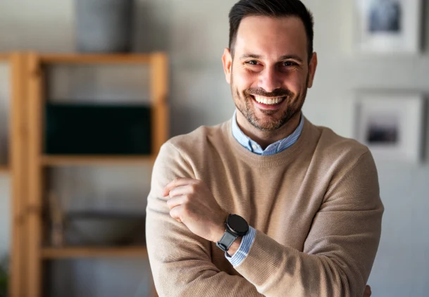 Smiling male dentist in casual attire at Clewiston dental practice.