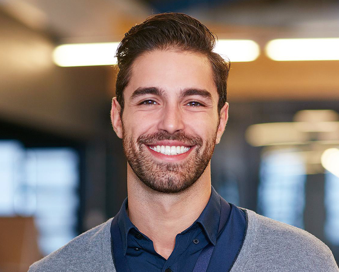 Patient smiling brightly after professional teeth whitening treatment.”