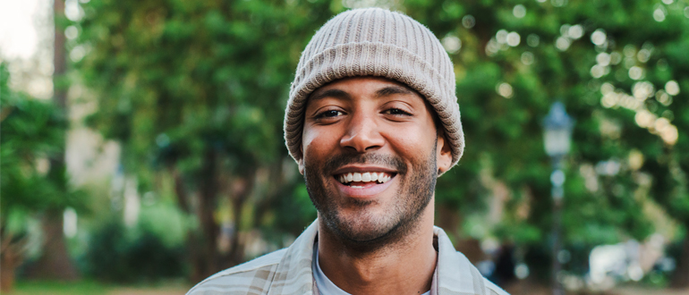 Patient smiling after completing dental crowns and bridges treatment.