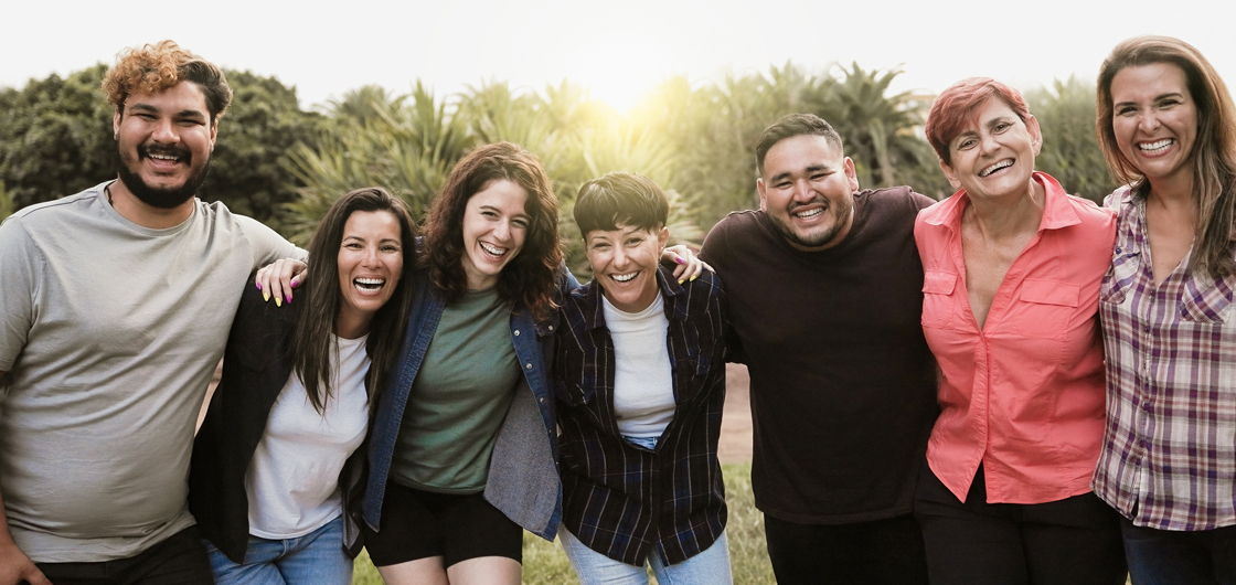 Smiling family group photo after restorative dental treatment at Hallmark Dental.