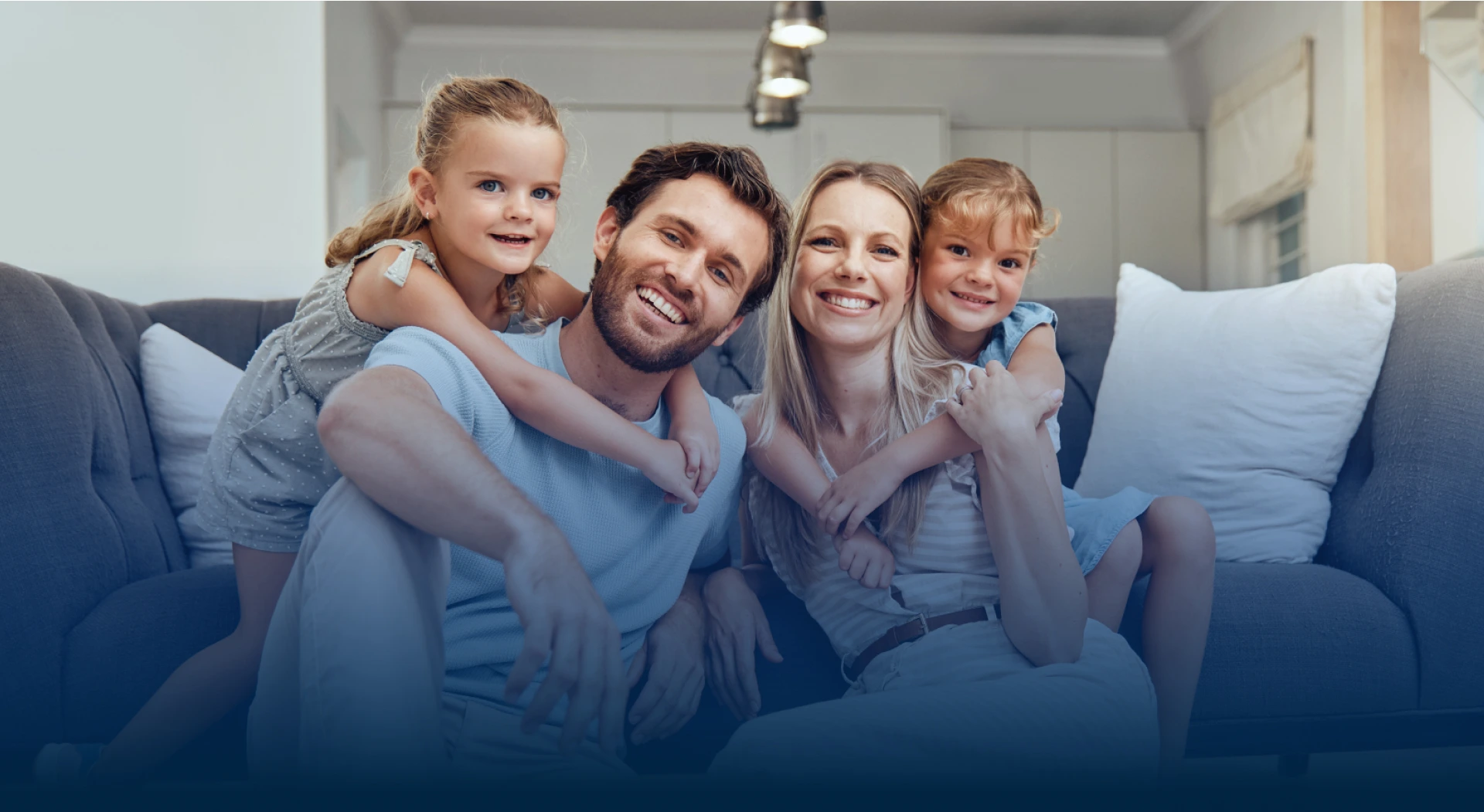 Happy family smiling at home representing family dental care in Austin TX at Hapii Dental