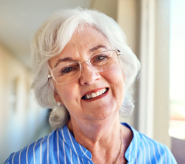 Senior woman smiling after expert tooth extraction care in Alpharetta.