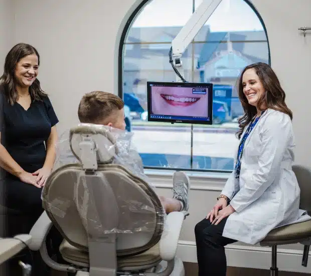 Dentist reviewing a patient's smile with digital imaging at Katy Smile Design