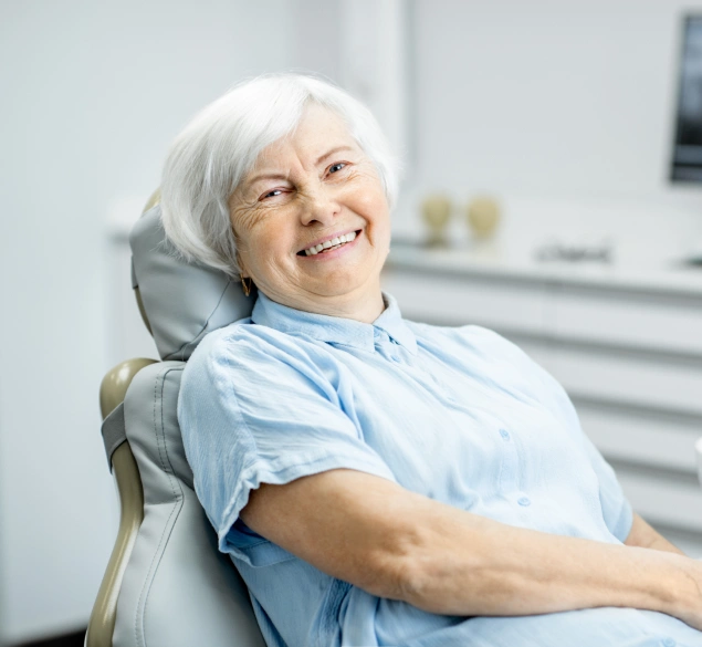Senior woman seated in a dental treatment room for root canal treatment at Lilburn Smile Makers Dental in Lilburn, Georgia