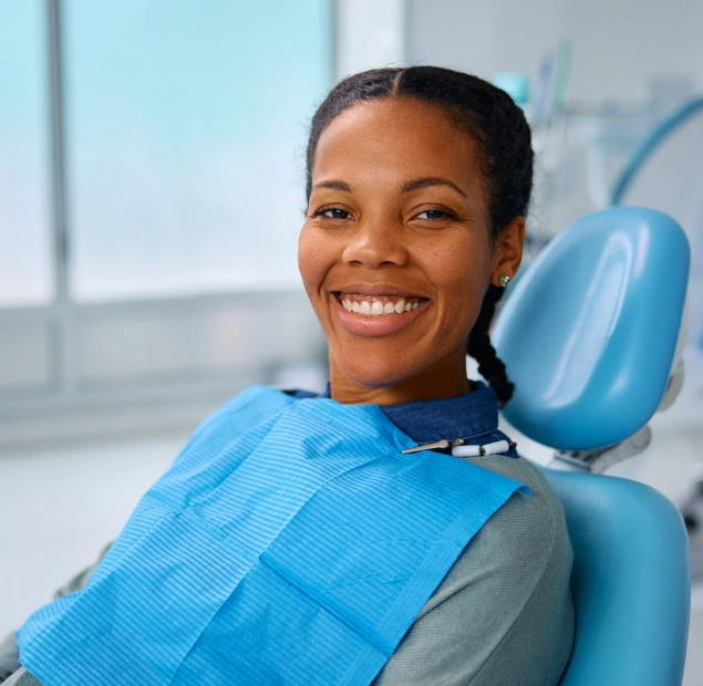 Woman seated in a dental chair for teeth whitening treatment at Lilburn Smile Makers Dental in Lilburn, Georgia