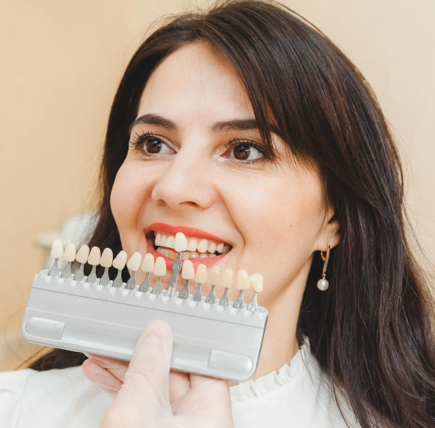 Dentist in Lilburn assisting a young woman in choosing the right veneer shades at Lilburn Smile Makers Dental