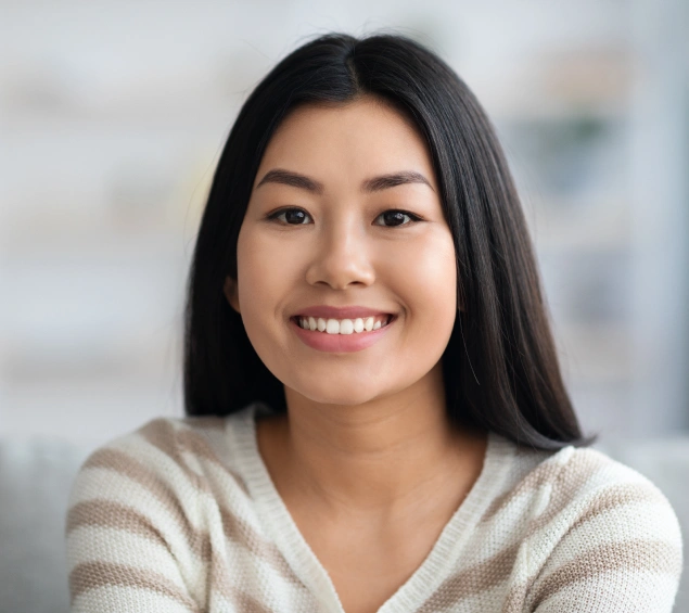 Young woman smiling brightly after receiving root canal treatment at Lilburn Smile Makers Dental in Lilburn, Georgia