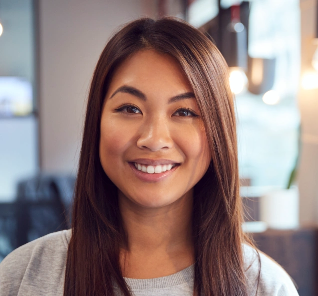 Woman smiling brightly after receiving a dental bridge for a missing tooth at Lilburn Smile Makers Dental in Lilburn, Georgia