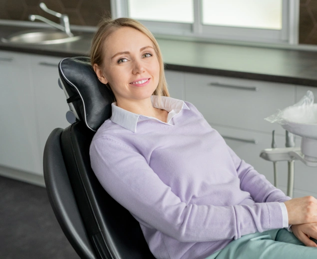 Young woman seated in a dental treatment room for periodontal disease treatment at Lilburn Smile Makers Dental in Lilburn, Georgia
