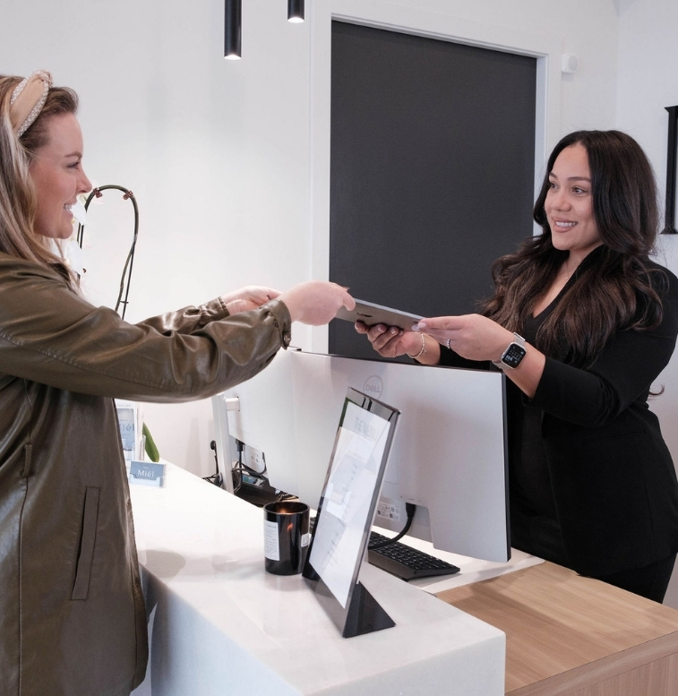 patient at the front desk of Miel Dental Aesthetics