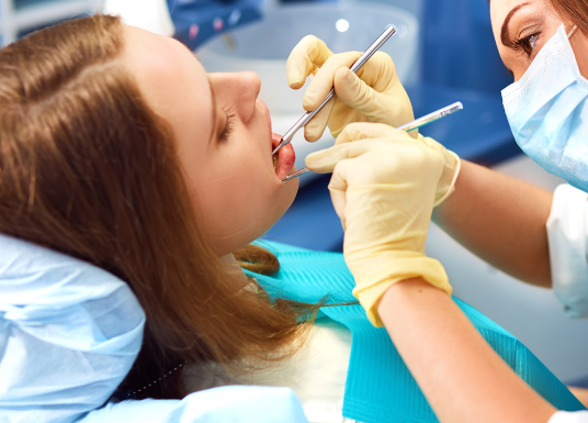 Dental professional performing a preventive holistic dentistry procedure on a patient