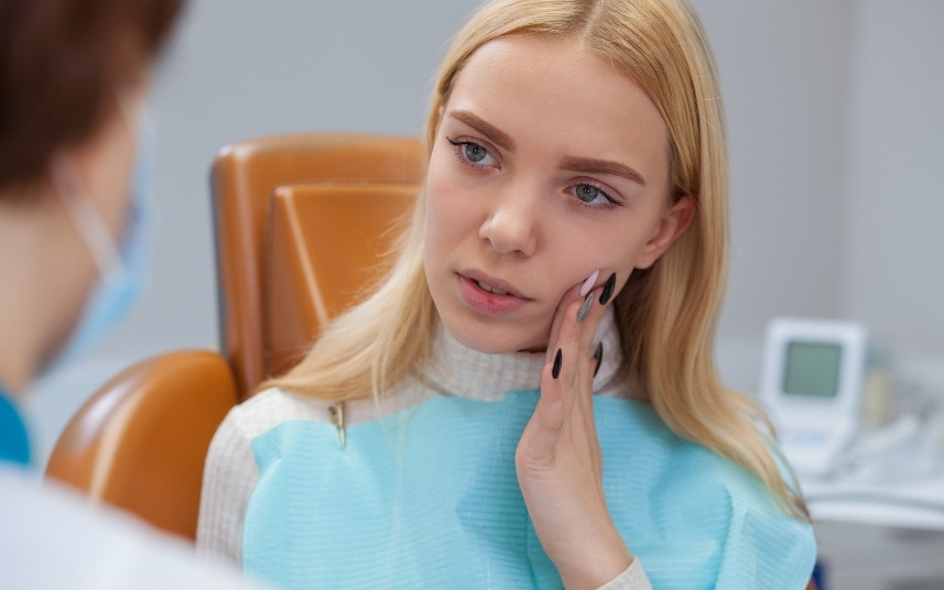 Woman with jaw pain and dental discomfort