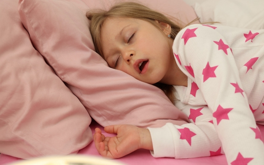 Child sleeping with mouth open due to heavy breathing and airway issues