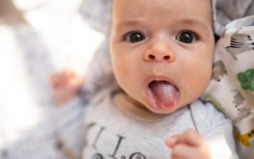 Infant with tongue tie condition affecting oral development