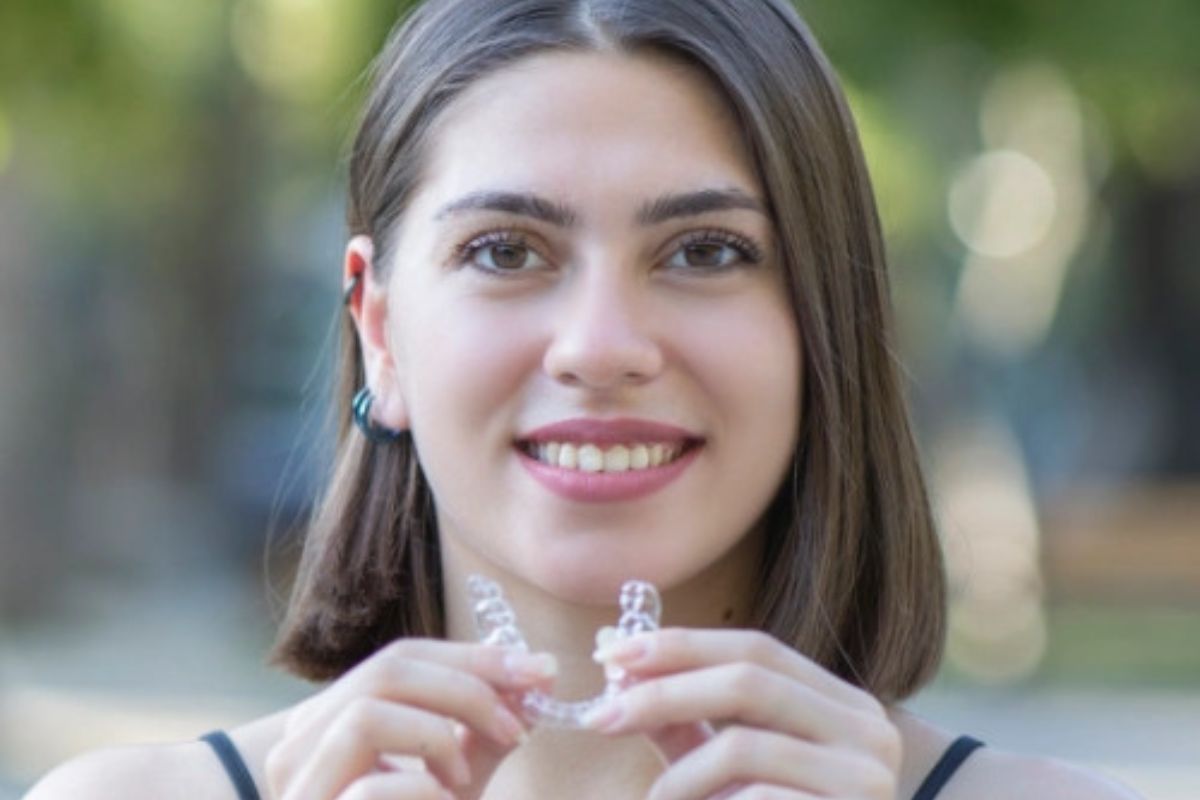 Woman smiling showing her straight teeth after Invisalign treatment in Hayden