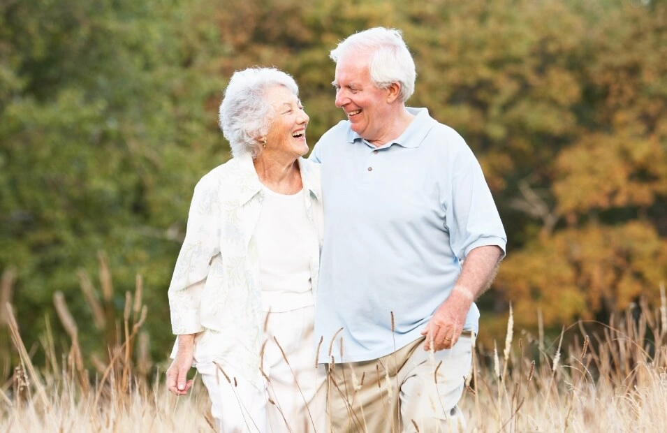 Elderly couple laughing and enjoying time together outdoors