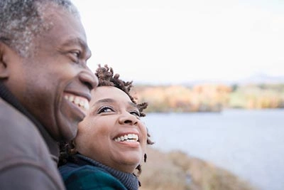 A couple laughing in an outdoor setting