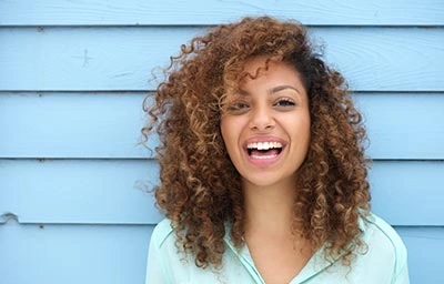 Patient smiling after receiving metal free dental implants at Northwest Natural Dentistry