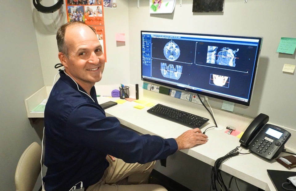 Dentist reviewing digital X rays on a computer screen