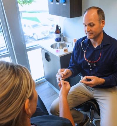 Dentist consulting with a patient about Invisalign and clear aligners