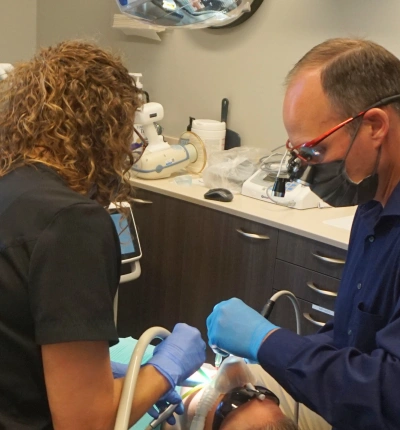 Dentist performing a root canal procedure on a patient