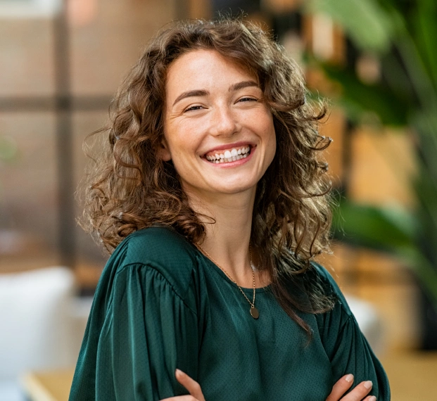 Female patient smiling in scrubs at Pacific Crest Dental Group