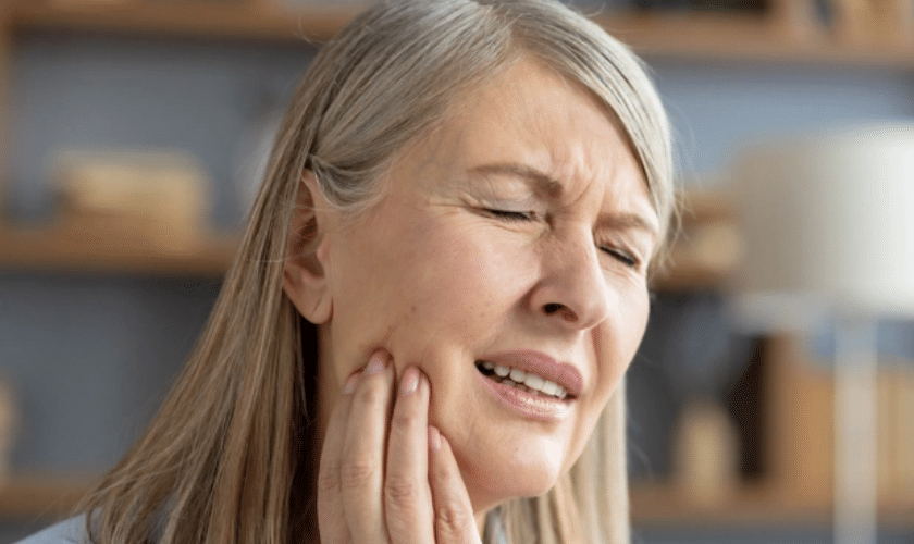 Patient experiencing tooth pain due to delayed dental care in Bellevue WA highlighting importance of early dental visits
