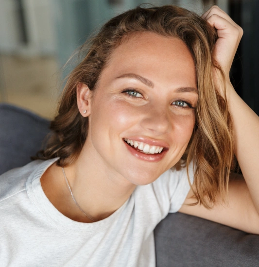 A female patient smiling after cosmetic dental treatment.