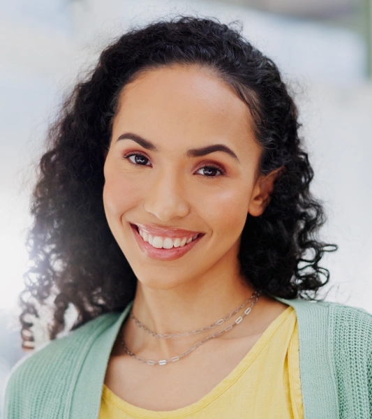 A female patient smiling after preventative dental care treatment