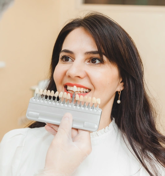 Dentist assisting a patient in choosing the right veneer shade at Rocklin Comprehensive Dentistry
