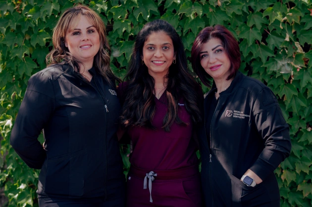Dr. Purna Patel with Jenny and Misty in a group photo at Rocklin Comprehensive Dentistry in Rocklin, California.