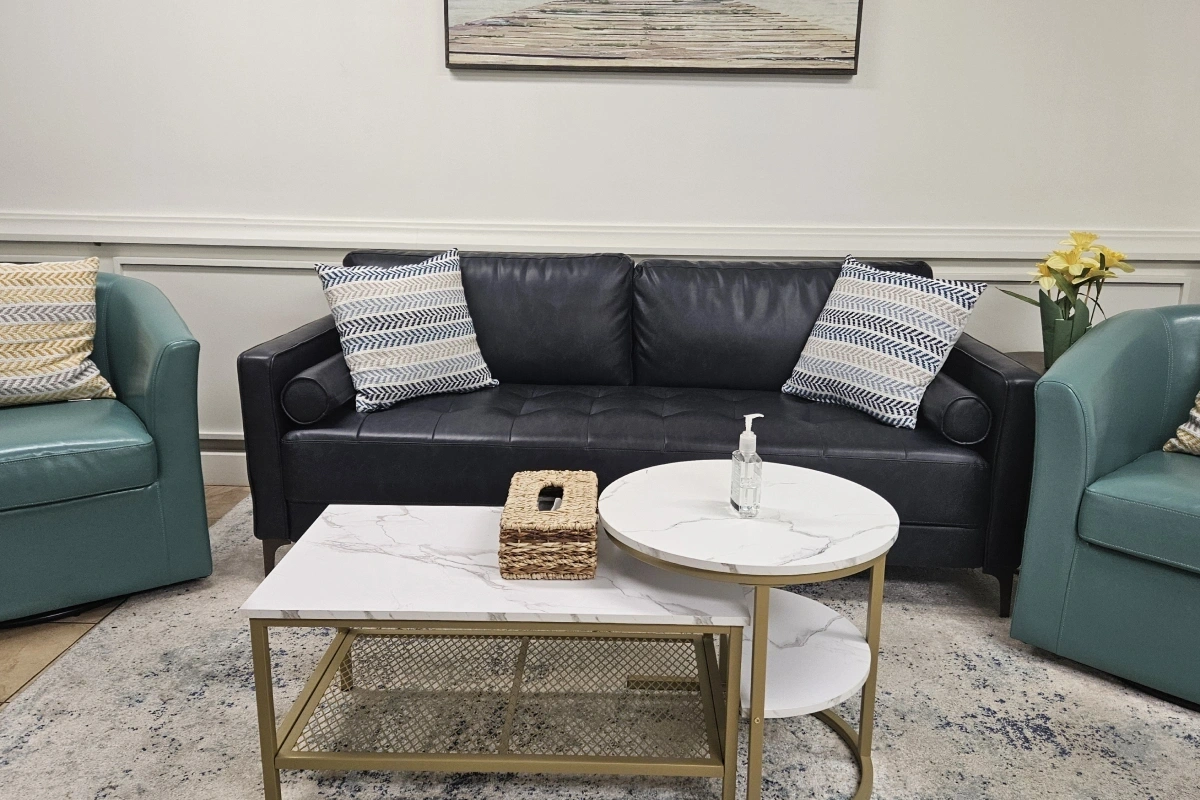 Patient waiting area with seating and coffee table at Rollstone Family Dental